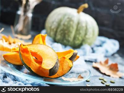 raw pumpkin on plate and on a table