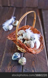 raw quail eggs in the basket and on a table