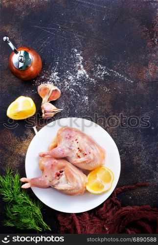 raw quail with salt and lemon on plate