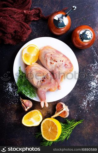 raw quail with salt and lemon on plate