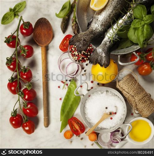 Raw rainbow trout with vegetables, herbs and spices - Health or Cooking concept