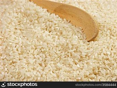raw rice and wooden spoon