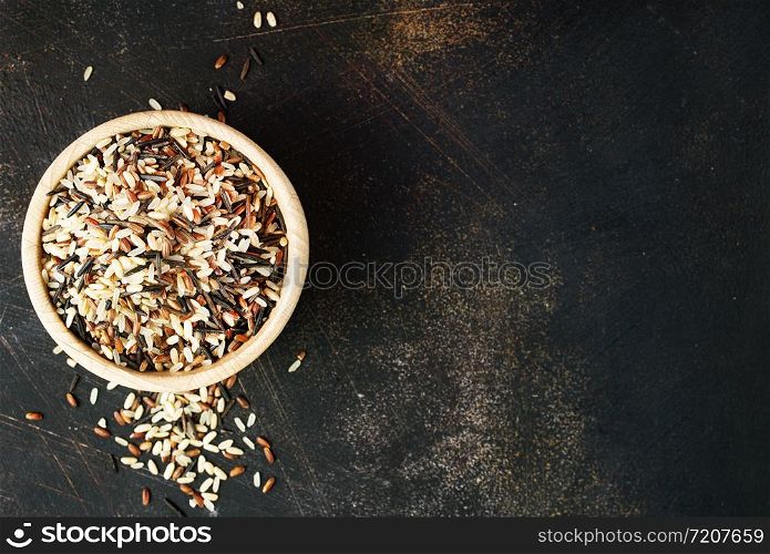 raw rice in wooden bowl on a table