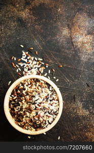 raw rice in wooden bowl on a table