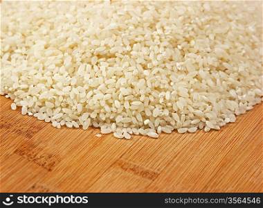 raw rice on bamboo board