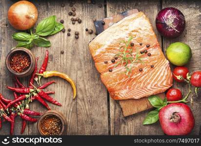 Raw salmon fillet on wooden cutting board. Fresh raw salmon fish