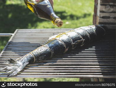 Raw salmon fish on grill. Outdoor cooking