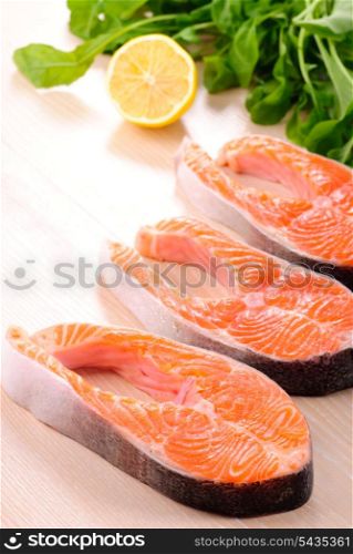 Raw salmon steak in row, prepared for cooking