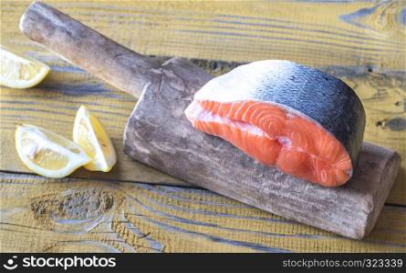 Raw salmon steak on the wooden board