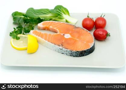 raw salmon steak with vegetable on plate, food and vegetable concept
