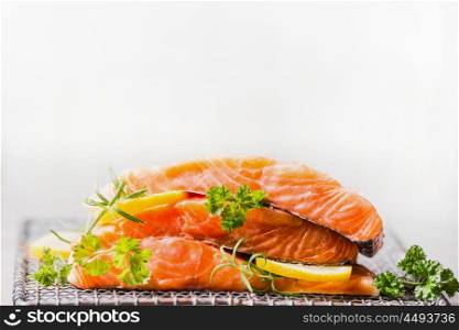Raw salmon with lemon for tasty cooking on light background, side view