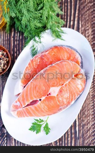 raw salmon with pepper and salt on a table