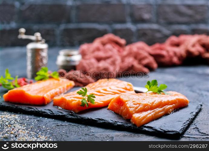 raw salmon with spice and salt on board
