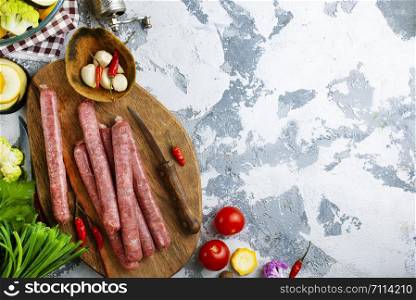 raw sausages with aroma spice on wooden board