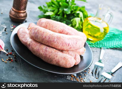 raw sausages with salt and spice on a table