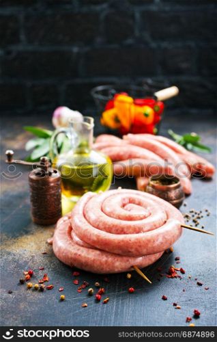 raw sausages with spice on a table