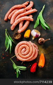 raw sausages with spice on a table