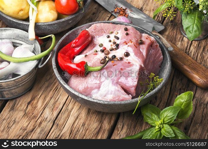 Raw sirloin pork meat. Raw section meat. Piece of fresh pork meat with spices on old rustic table