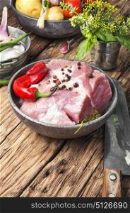 Raw sirloin pork meat. Raw section meat. Piece of fresh pork meat with spices on old rustic table