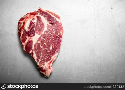 Raw steak of beef. On rustic background.. Raw steak of beef.