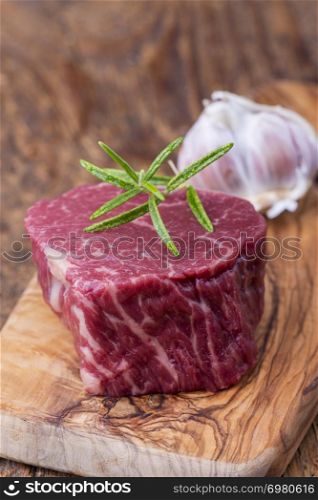 raw steak on dark wood