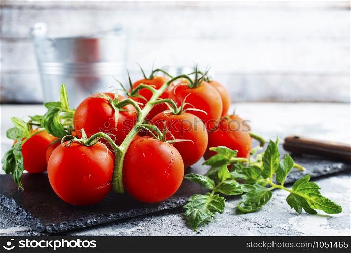 raw tomato, tomato cherry on black board