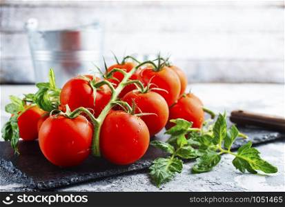 raw tomato, tomato cherry on black board