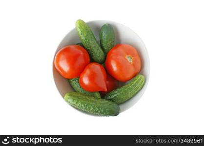 Raw tomatoes and cucumbers on a plate isolated