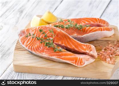Raw trout steaks on the wooden board
