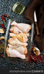 Raw uncooked chicken legs with ingredients for cooking