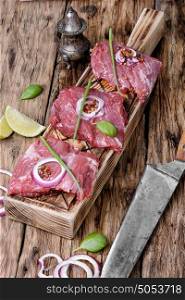 Raw veal meat.. Raw meat.Raw beef with spices on the kitchen Board