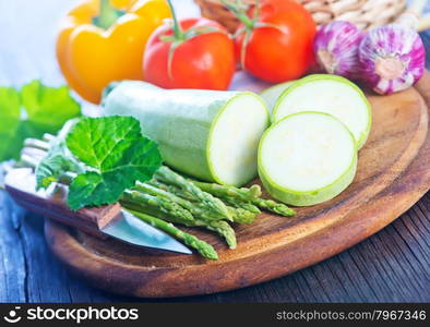 raw vegetables and knife on the wooden board