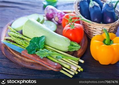 raw vegetables and knife on the wooden board