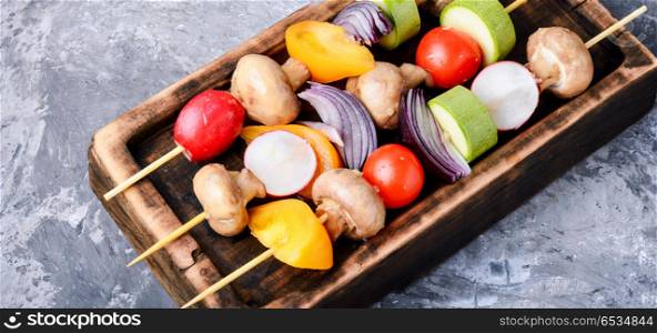 Raw vegetables on skewers. Vegan vegetable skewers on a cutting board.Vegetables for grilling