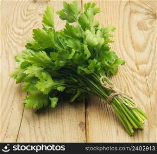Raw vegetables with parsley on wooden background