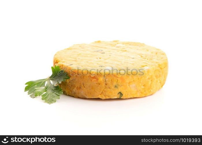 Raw veggie burger with chickpeas and vegetables with parsley leaves on white background.