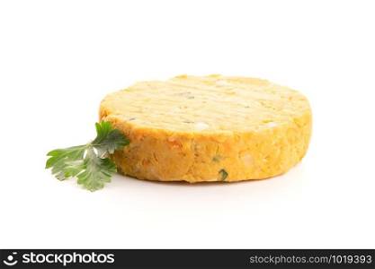 Raw veggie burger with chickpeas and vegetables with parsley leaves on white background.