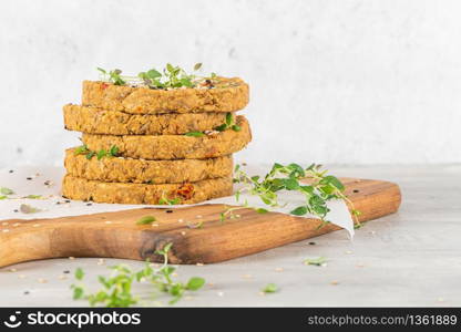 Raw veggie burger with lentils, vegetables and thyme leaves on kitchen countertop. Top view. Flat lay