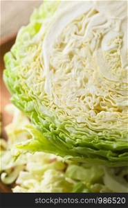 Raw white cabbage quartered photographed close-up (Selective Focus, Focus one third into the cabbage). Raw White Cabbage