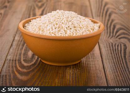 raw white rice in a Cup on a wooden table