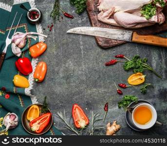 Raw whole chicken with oil and vegetables ingredients for cooking on rustic background, frame, top view. Healthy food or diet eating concept.