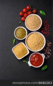 Raw whole grain orzo pasta as an ingredient for a delicious dish. Mediterranean cuisine dish