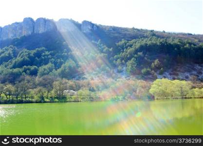 Ray of sunshine from the mountain lake. Mangup-Kale, Crimea, Ukraine,