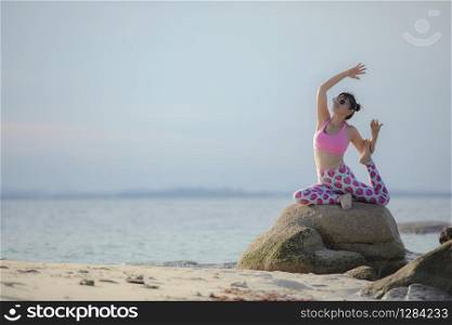 RAYONG THAILAND - MAY2,2018 : three asian woman playing yoga on sea beach ,yoga is popular trend for modern lifestyle people in thailand