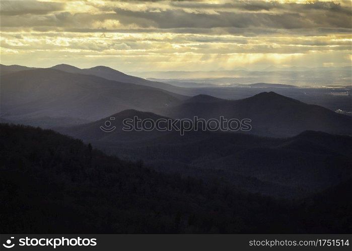 Rays of light shining across the layers of the Appalachian Mountains in Shenandoah National Park at sunset.