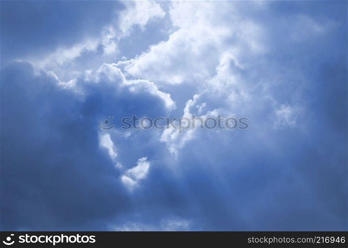 Rays of sunshine breaks through the dark blue clouds. Concept of hope for the best, mood changes, the breakthrough goal. Rays of sunshine breaks through the dark blue clouds.