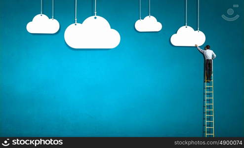 Reaching top. Businessman climbing ladder to top and touching cloud