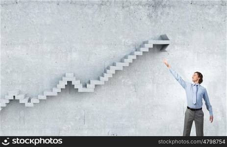 Reaching top of success. Businessman reaching hand to touch stone growing arrow graph