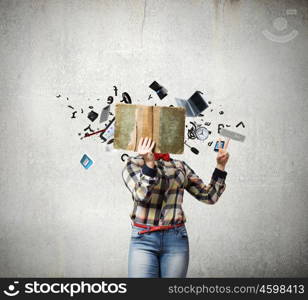 Reading concept. Woman in casual wear hiding her face behind book