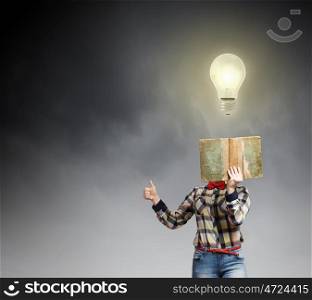 Reading concept. Woman in casual wear hiding her face behind book